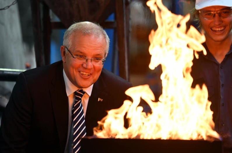 Prime Minister Scott Morrison leans over a gas cauldron, net zero emissions be damned.