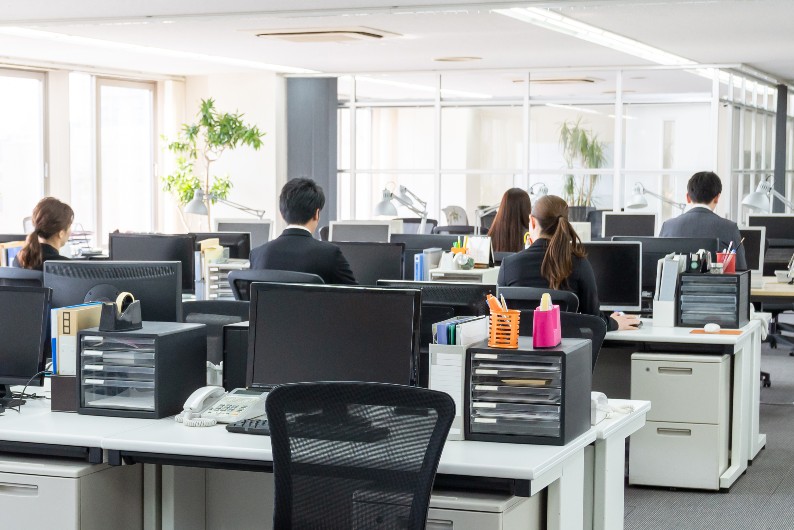 office workers writing at their desks