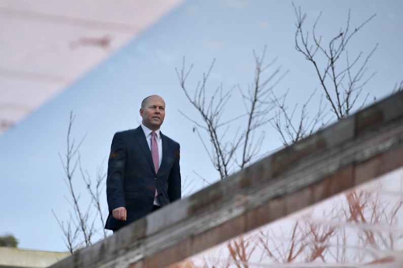 Josh Frydenberg reflected in water.