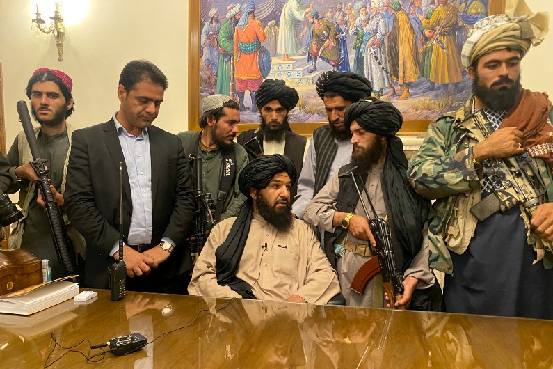 Taliban fighters take control of Afghan presidential palace after the Afghan President Ashraf Ghani fled the country, in Kabul, Afghanistan, Sunday, Aug. 15, 2021. (AP Photo/Zabi Karimi)