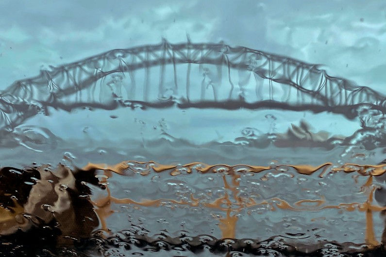 Sydney-harbour-bridge seen through a rainy car windscreen