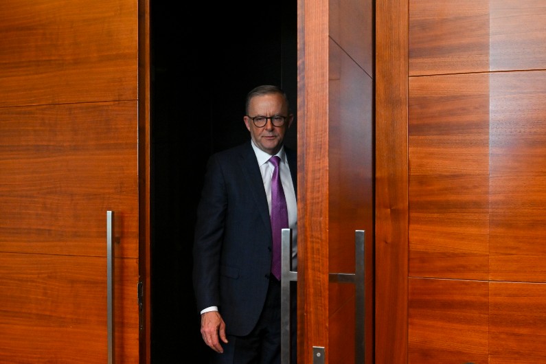 Anthony Albanese standing in a dark doorway